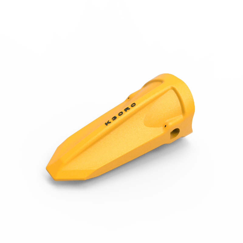 K30RC Hensley-style rock bucket tooth in yellow casting finish, showing the chisel point tip, the raised central rib along the top, the side retention lug, and the cast part number K30RC on the tooth body
